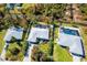 Aerial view of three homes, two with pools at 7171 Teaberry St, Englewood, FL 34224