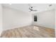 Sunlit bedroom featuring wood-look floors and a ceiling fan at 590 Rutland Cir, Port Charlotte, FL 33954