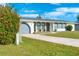 White single-story home with gray roof and garage at 20 Annapolis Ln, Rotonda West, FL 33947