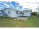 White house exterior with a large concrete patio and grassy yard at 20 Annapolis Ln, Rotonda West, FL 33947