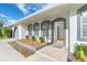 Front entrance with gray door and screen door at 20 Annapolis Ln, Rotonda West, FL 33947