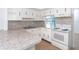 White kitchen with granite countertops and appliances at 20 Annapolis Ln, Rotonda West, FL 33947