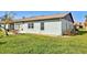 Back of house with light blue exterior and small patio at 612 Deerwood Ave # 169, Englewood, FL 34223