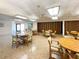 Well-lit game room with several tables and chairs at 612 Deerwood Ave # 169, Englewood, FL 34223