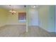 Light yellow dining room with tile floors and chandelier at 612 Deerwood Ave # 169, Englewood, FL 34223