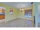 Bright dining room with tile floors and chandelier, open to kitchen at 612 Deerwood Ave # 169, Englewood, FL 34223