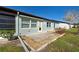 Back of house with light blue exterior and small patio at 612 Deerwood Ave # 169, Englewood, FL 34223