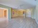 Open living room with tile floors, high ceilings and multiple views at 612 Deerwood Ave # 169, Englewood, FL 34223