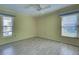 Bright bedroom with wood-look tile floors and two windows at 612 Deerwood Ave # 169, Englewood, FL 34223
