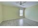 Bright bedroom with wood-look tile flooring and large window at 612 Deerwood Ave # 169, Englewood, FL 34223