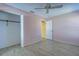 Bedroom with pink walls, wood-look floors and a closet at 612 Deerwood Ave # 169, Englewood, FL 34223