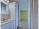 Bathroom with white vanity and view of bedroom at 612 Deerwood Ave # 169, Englewood, FL 34223