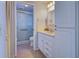 Updated bathroom with white vanity, tile shower, and linen storage at 612 Deerwood Ave # 169, Englewood, FL 34223