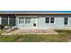 Back of house with light blue exterior and small patio at 612 Deerwood Ave # 169, Englewood, FL 34223