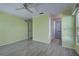 Bedroom with wood-look floors, ceiling fan, and en-suite bathroom at 612 Deerwood Ave # 169, Englewood, FL 34223