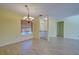 Dining room features tile floors, chandelier, and adjacent living space at 612 Deerwood Ave # 169, Englewood, FL 34223
