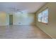 Living room with tile floors, large window, and ceiling fan at 612 Deerwood Ave # 169, Englewood, FL 34223