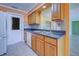 Kitchen with wood cabinets, dark countertops and sink at 612 Deerwood Ave # 169, Englewood, FL 34223
