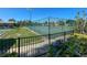 Well-maintained tennis court with surrounding fence at 612 Deerwood Ave # 169, Englewood, FL 34223