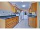 Kitchen with wood cabinets, dark countertops, and appliances at 612 Deerwood Ave # 169, Englewood, FL 34223