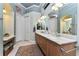 Large bathroom with double vanity, ample counter space, and a walk-in closet at 10 Boca Royale Blvd, Englewood, FL 34223