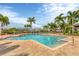 Resort-style pool with palm trees and brick pavers at 10300 Coral Landings Ct # 93, Placida, FL 33946