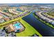 Beautiful aerial shot of a community with a lake, pool, clubhouse, and lush landscaping at 13092 Rinella St, Venice, FL 34293