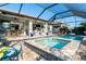 Enclosed pool and spa area with a basketball hoop at 13092 Rinella St, Venice, FL 34293