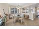 Bright dining area with glass-top table and four chairs near the kitchen at 13313 Gasparilla Rd # C205, Placida, FL 33946