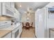 Kitchen with white cabinets, breakfast bar, and stainless steel appliances at 13313 Gasparilla Rd # C205, Placida, FL 33946