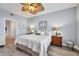 King-size bed, hardwood floors, ceiling fan, and access to private bath at 13313 Gasparilla Rd # C205, Placida, FL 33946