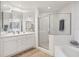 Clean bathroom with double vanity, large shower, and soaking tub at 13313 Gasparilla Rd # C205, Placida, FL 33946