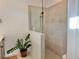 Modern bathroom showcasing a tiled walk-in shower with glass partition and neutral color tones, providing a spa-like retreat at 19060 Moscato Ct, Venice, FL 34293