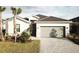 This home has an attached two-car garage, complimented by mature landscaping at 19060 Moscato Ct, Venice, FL 34293