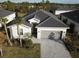 Beautiful aerial shot of a single Gathering home showcasing dark roof and an attached two-car garage at 19060 Moscato Ct, Venice, FL 34293