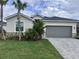Inviting single-Gathering home showcasing lush landscaping and a well-maintained two car garage at 19060 Moscato Ct, Venice, FL 34293