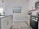 Modern kitchen with stainless steel appliances, white cabinetry, and a stylish backsplash at 19060 Moscato Ct, Venice, FL 34293