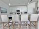 Kitchen featuring white cabinets and countertops, stainless appliances, and barstool seating at 19060 Moscato Ct, Venice, FL 34293