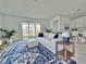 Sunlit living room with a plush white sofa, blue patterned rug, and scenic backyard view at 19060 Moscato Ct, Venice, FL 34293