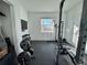 Well-equipped workout room featuring weights, weight rack and a window at 19060 Moscato Ct, Venice, FL 34293