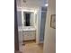 Bathroom with shower, vanity, and hexagonal tile floor at 26 Quails Run Blvd # 7, Englewood, FL 34223