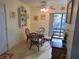 Cozy dining area with a glass table and four chairs at 26 Quails Run Blvd # 7, Englewood, FL 34223