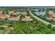 Aerial view of home with pool and lush landscaping, situated in a desirable community at 2619 Wax Myrtle Ct, Port Charlotte, FL 33953