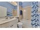 Bathroom with a shower/tub combo, vanity, and blue walls at 2803 Sawgrass Ct, Port Charlotte, FL 33953