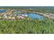 Aerial view of a tranquil waterfront community with houses surrounded by lush greenery at 2803 Sawgrass Ct, Port Charlotte, FL 33953