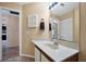 Neutral toned bathroom with updated vanity, large mirror, and chrome fixtures at 514 Pine Hollow Cir # 514, Englewood, FL 34223