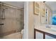 Bathroom featuring glass shower, light vanity, and neutral toned walls at 514 Pine Hollow Cir # 514, Englewood, FL 34223