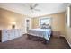 Cozy bedroom with neutral carpet and walls, two large windows providing ample natural light at 514 Pine Hollow Cir # 514, Englewood, FL 34223