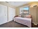 Bedroom with neutral tones, a window, and an accent lamp at 514 Pine Hollow Cir # 514, Englewood, FL 34223
