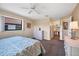 Bright bedroom featuring neutral walls, ceiling fan and ample closet space at 514 Pine Hollow Cir # 514, Englewood, FL 34223